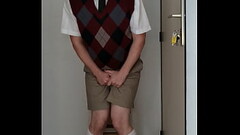 Uniformed schoolboy with dunce cap is desperate to pee in time out Thumb